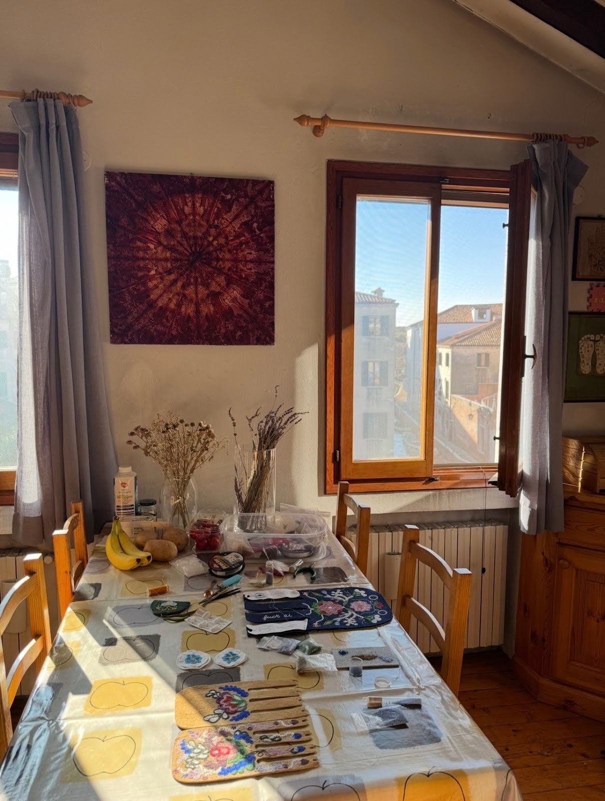 My beading set-up on the table in our shared apartment in Venice. (See the canal through the window). Photography Credit: Claire Johnston